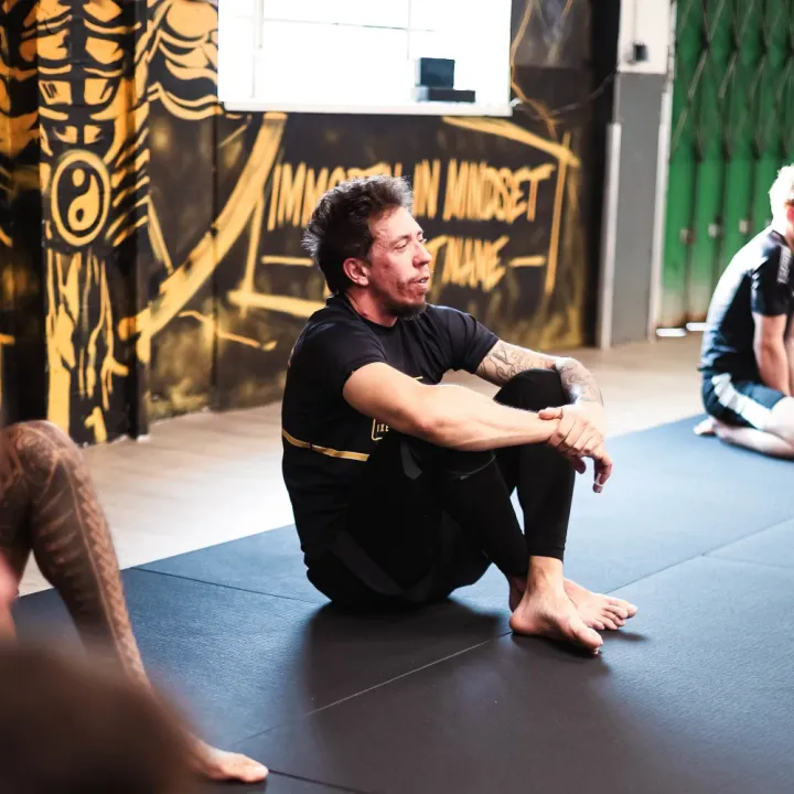 Jake sitting on the mats at Brazilian jiu-jitsu training